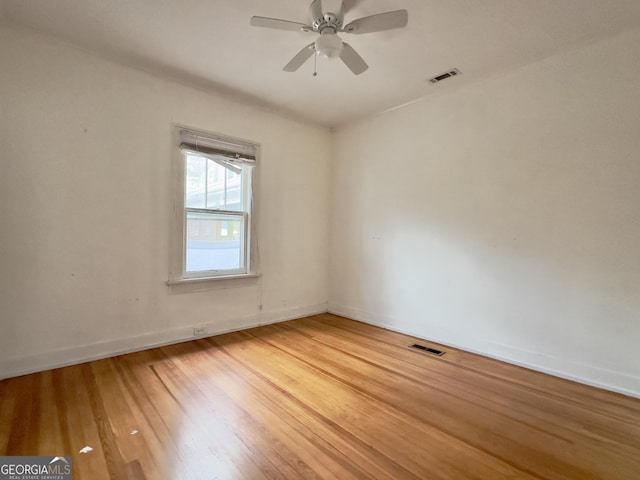 unfurnished room with hardwood / wood-style flooring and ceiling fan