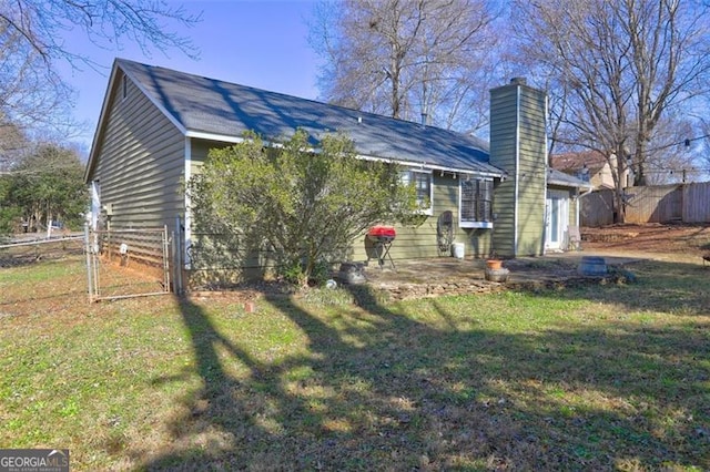 exterior space with a patio and a front lawn