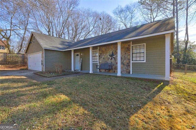 ranch-style home with a garage, a front yard, and covered porch