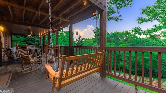 wooden deck featuring ceiling fan