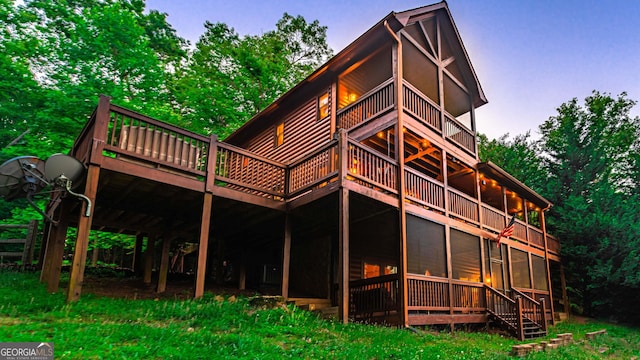 view of back house at dusk