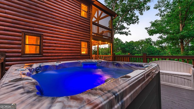 exterior space featuring a wooden deck and a hot tub