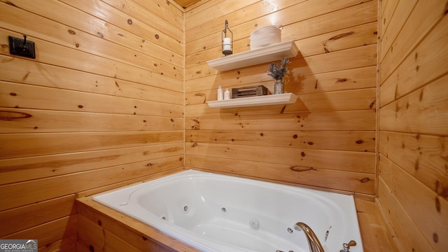 bathroom featuring wooden walls and tiled bath