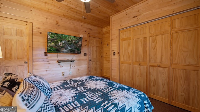 bedroom with wood ceiling, wooden walls, and a closet