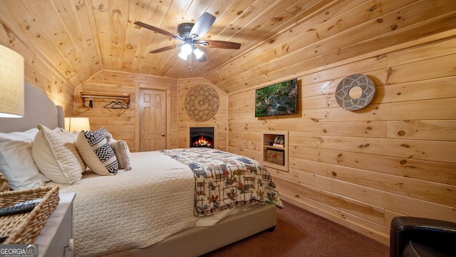 carpeted bedroom featuring wood ceiling, vaulted ceiling, ceiling fan, and wood walls