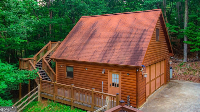 back of house with an outbuilding and a garage