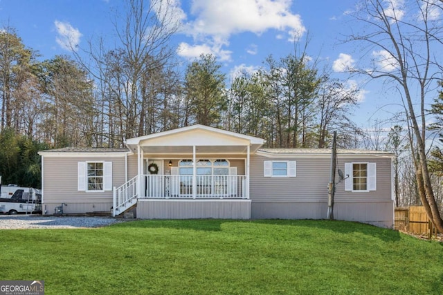 view of front of home with covered porch and a front yard