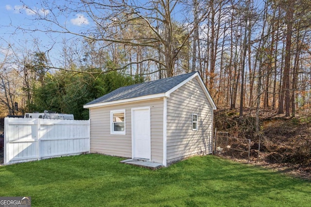 view of outbuilding with a lawn