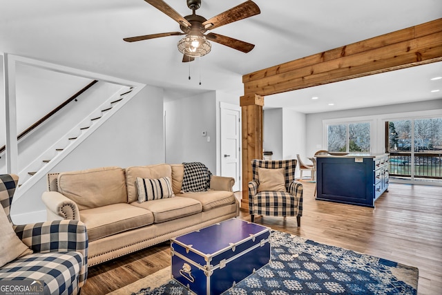 living room with ceiling fan and light wood-type flooring