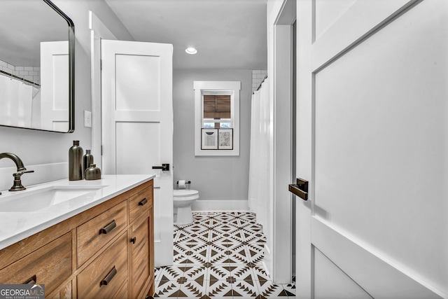 bathroom featuring vanity and toilet