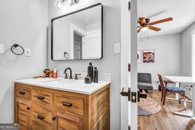 bathroom featuring ceiling fan, vanity, and hardwood / wood-style floors