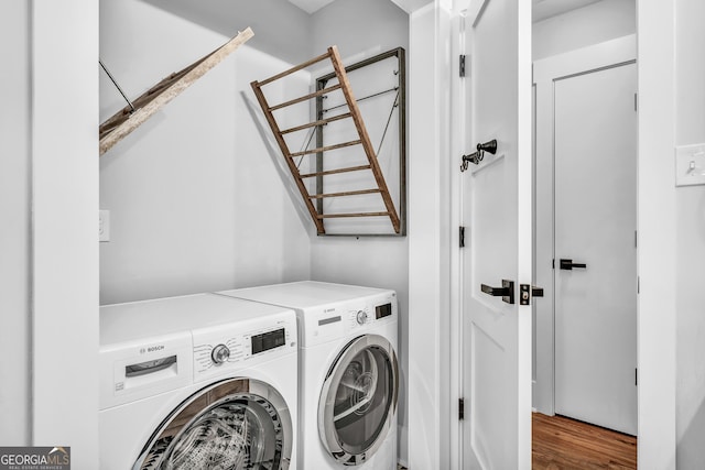 laundry area with wood-type flooring and independent washer and dryer