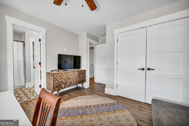 bedroom featuring a closet, ensuite bath, dark hardwood / wood-style floors, and ceiling fan