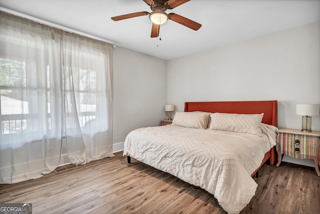 bedroom with ceiling fan and light wood-type flooring