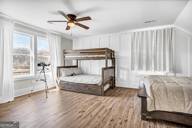 bedroom featuring light hardwood / wood-style flooring, ceiling fan, and vaulted ceiling