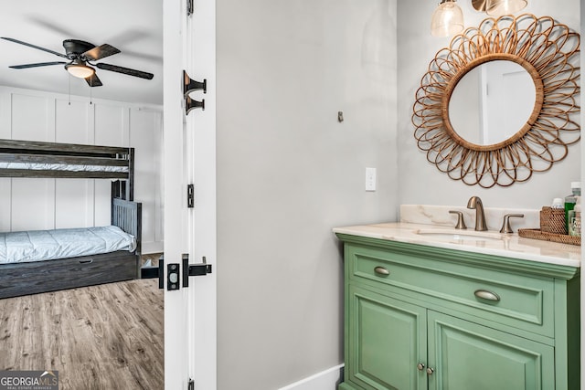 bathroom featuring vanity, wood-type flooring, and ceiling fan