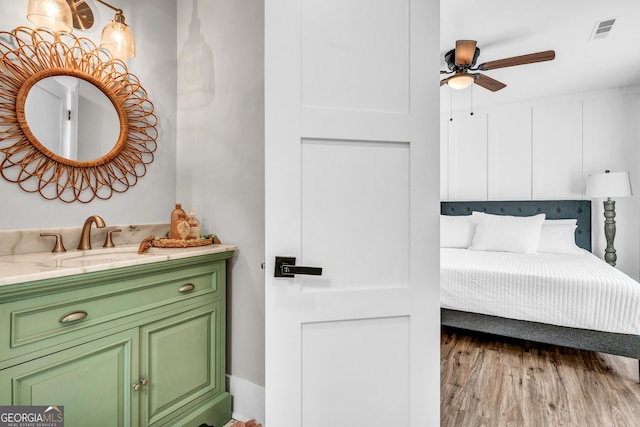 bedroom featuring sink and hardwood / wood-style flooring