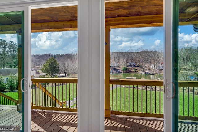 doorway with hardwood / wood-style flooring and a water view