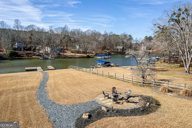 exterior space with a water view and an outdoor fire pit