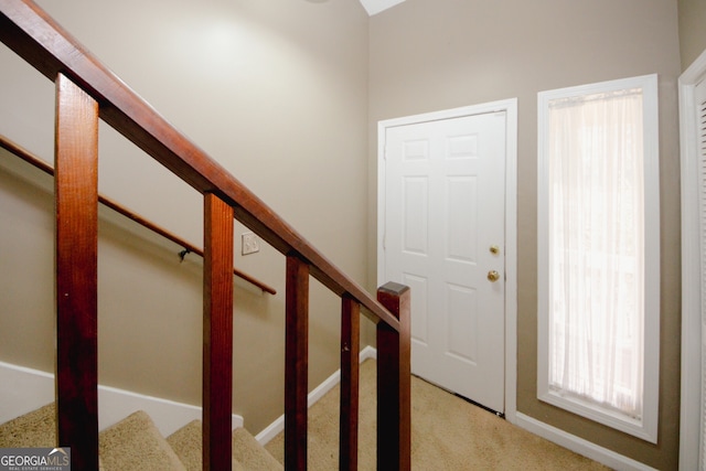 interior space featuring light carpet