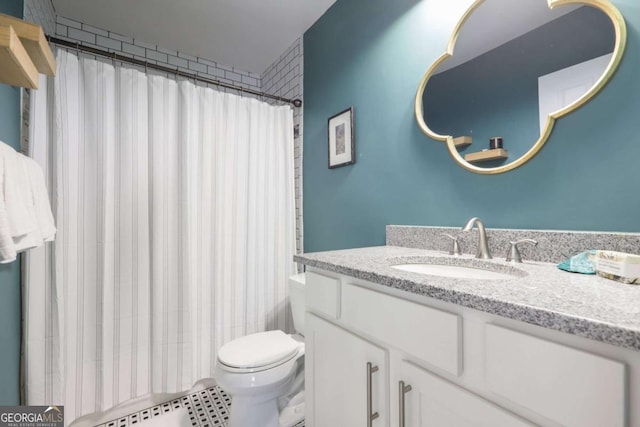 bathroom featuring vanity, toilet, and curtained shower