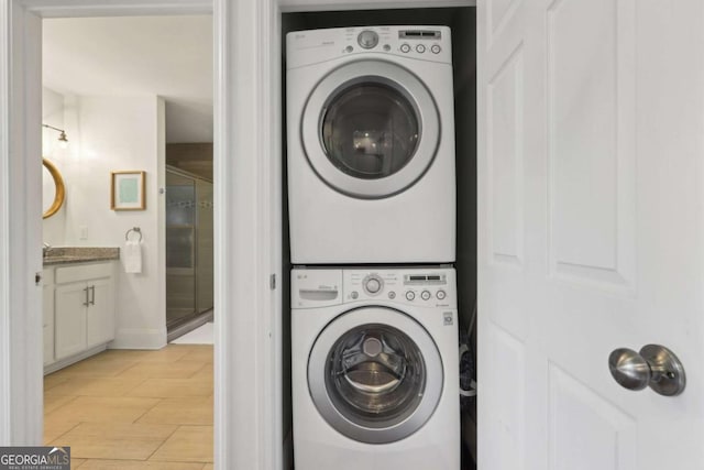 clothes washing area featuring stacked washing maching and dryer