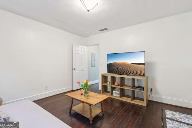 living room with dark wood-type flooring and electric panel