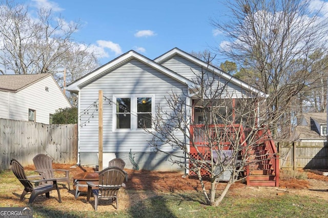 back of house with an outdoor fire pit