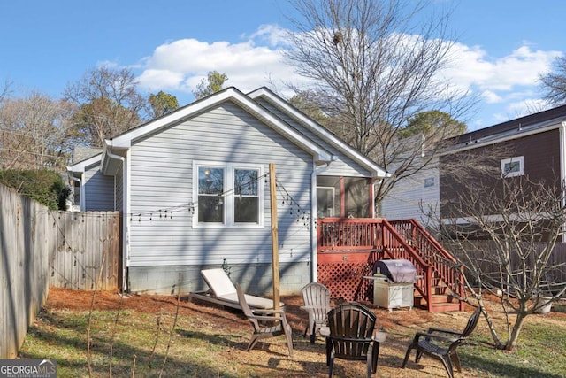 back of property featuring a wooden deck