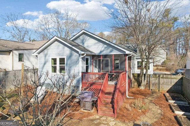 back of house featuring a sunroom