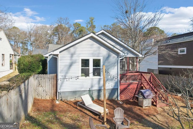 back of property with a sunroom