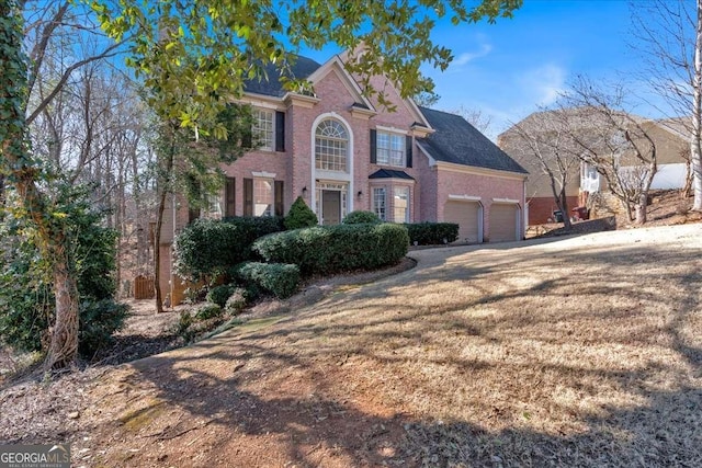 view of front of home with a garage and a front lawn