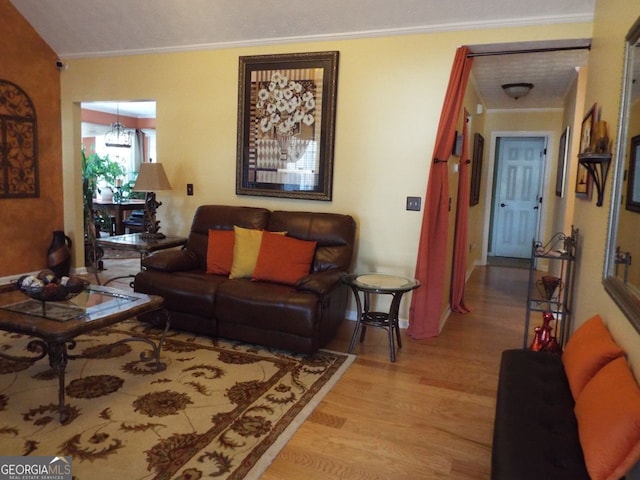 living room featuring ornamental molding and light wood-type flooring