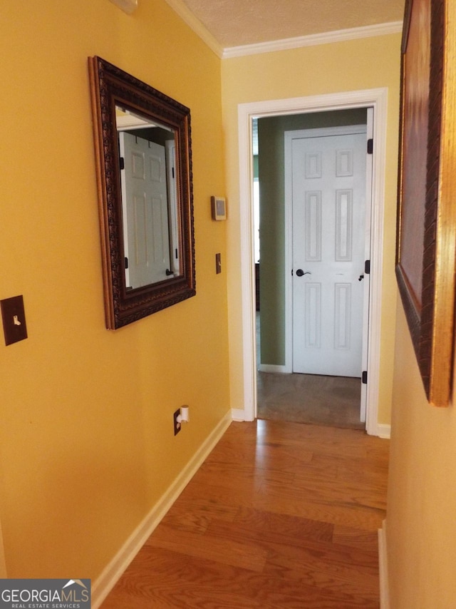 corridor featuring hardwood / wood-style floors and crown molding