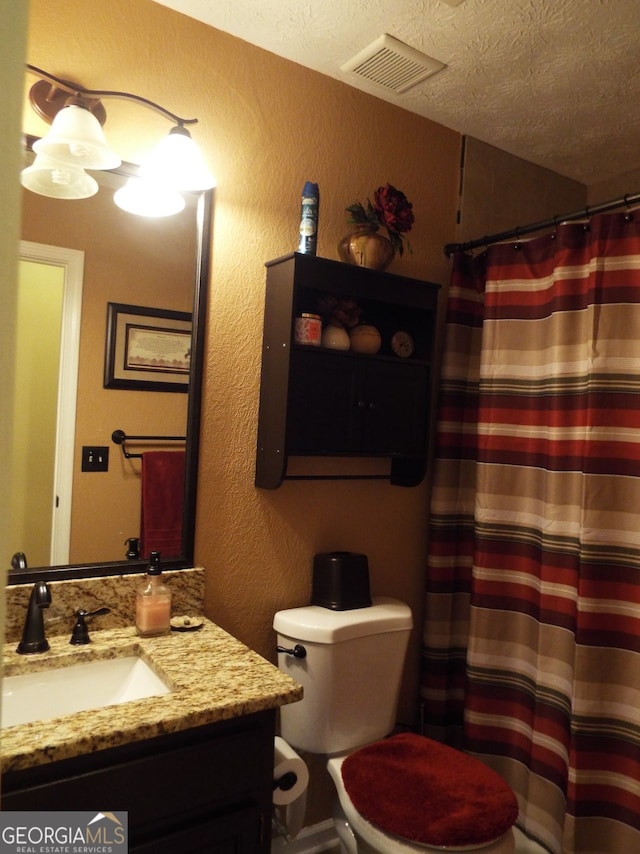 bathroom featuring vanity and a textured ceiling