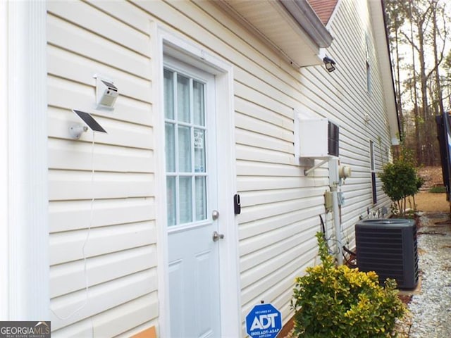 entrance to property featuring central air condition unit