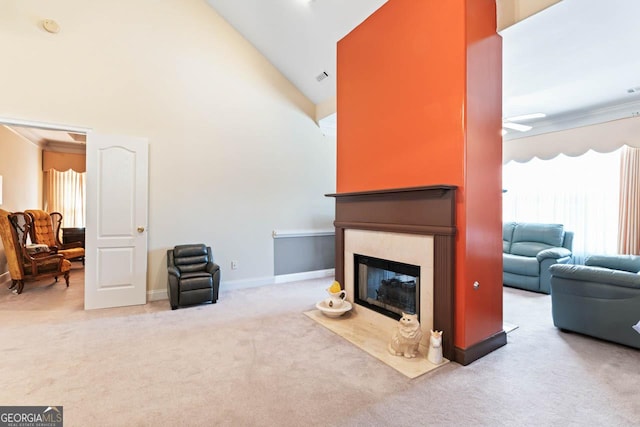 carpeted living room with high vaulted ceiling