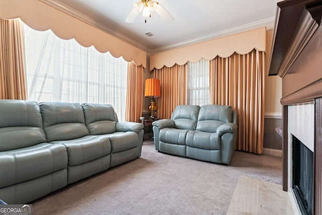 living room featuring crown molding, light colored carpet, and ceiling fan