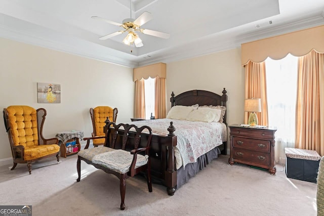 bedroom with light carpet, ornamental molding, a raised ceiling, and ceiling fan