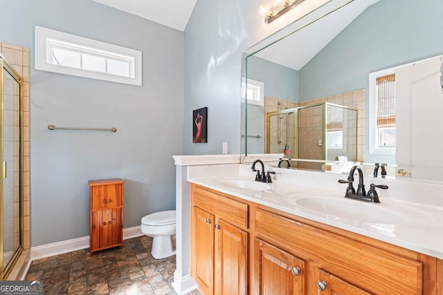 bathroom featuring walk in shower, lofted ceiling, a healthy amount of sunlight, and toilet