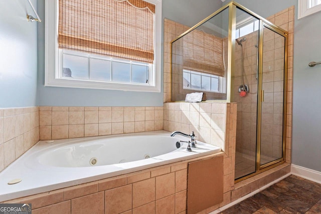 bathroom featuring independent shower and bath and plenty of natural light