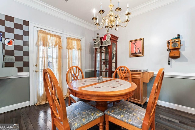 dining space with crown molding, dark hardwood / wood-style flooring, and an inviting chandelier