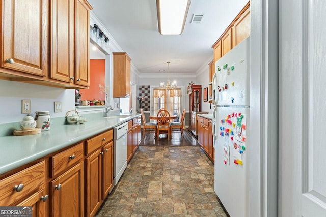 kitchen with sink, crown molding, hanging light fixtures, a notable chandelier, and white appliances