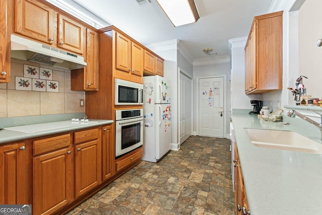 kitchen with crown molding, white appliances, sink, and backsplash