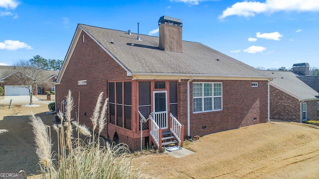 rear view of house featuring a sunroom