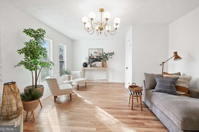 living area with light hardwood / wood-style floors and a chandelier