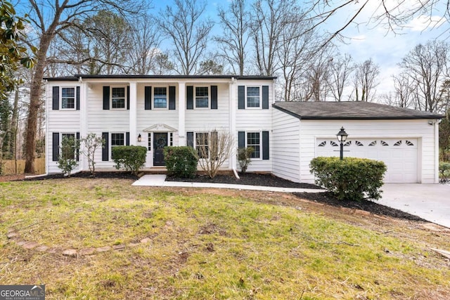 view of front of home featuring a garage and a front yard