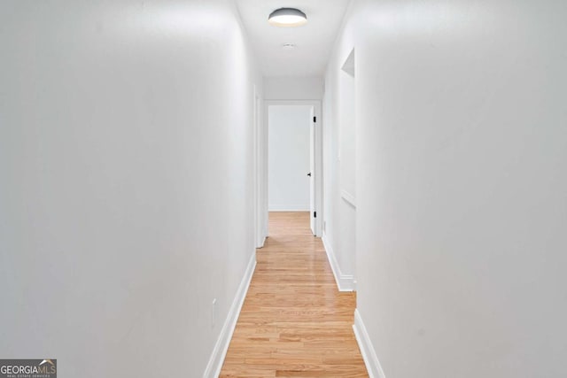 hallway with light wood-type flooring