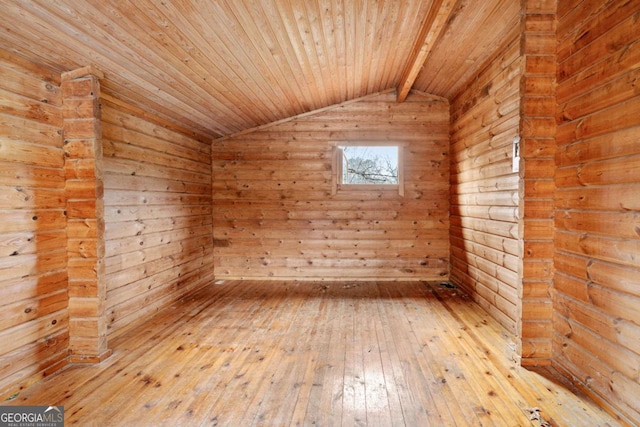 spare room featuring lofted ceiling, hardwood / wood-style floors, and wood ceiling