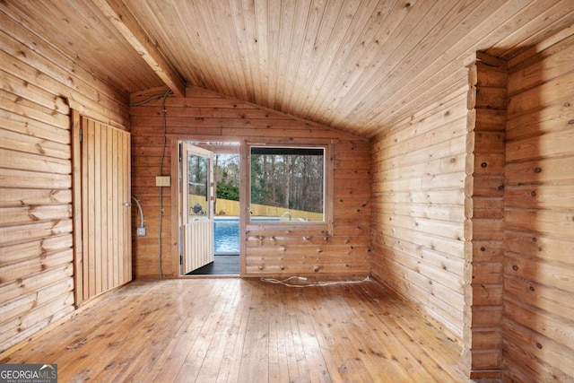 unfurnished room featuring vaulted ceiling with beams, wood ceiling, wood walls, and light wood-type flooring